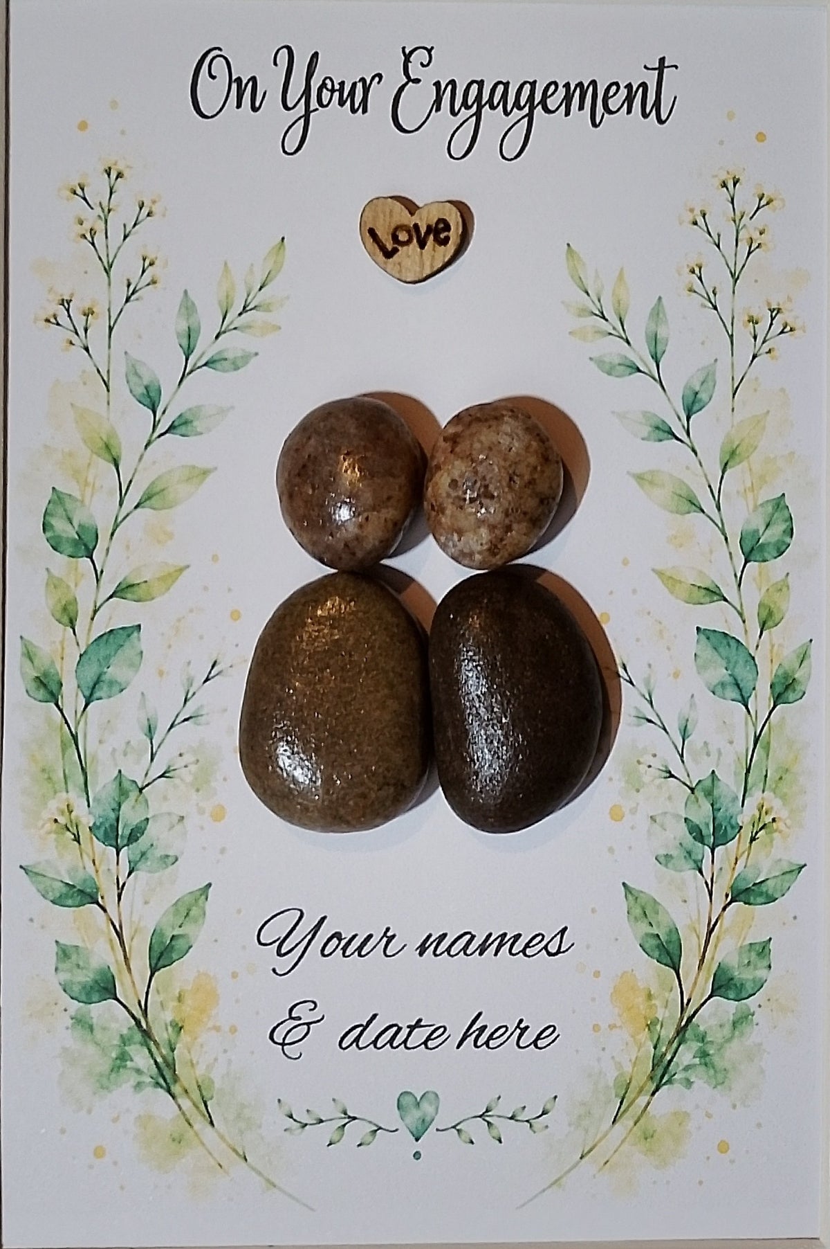 Personalisation example — Engagement picture showing names and date beneath the pebble couple.